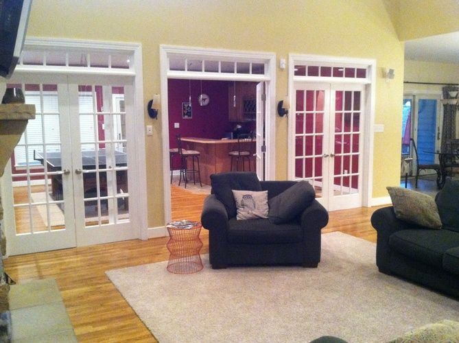 A living room with a black couch and a black chair