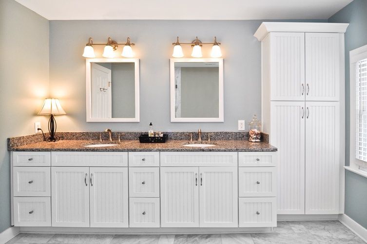 A bathroom with two sinks and two mirrors