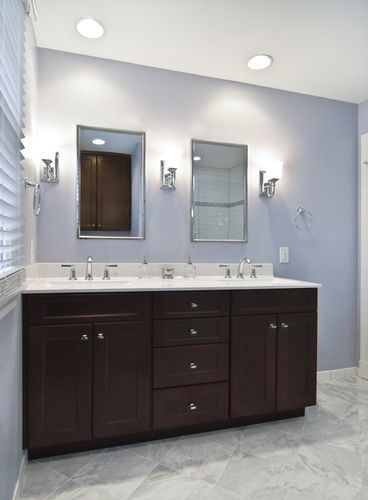 A bathroom with two sinks and two mirrors.