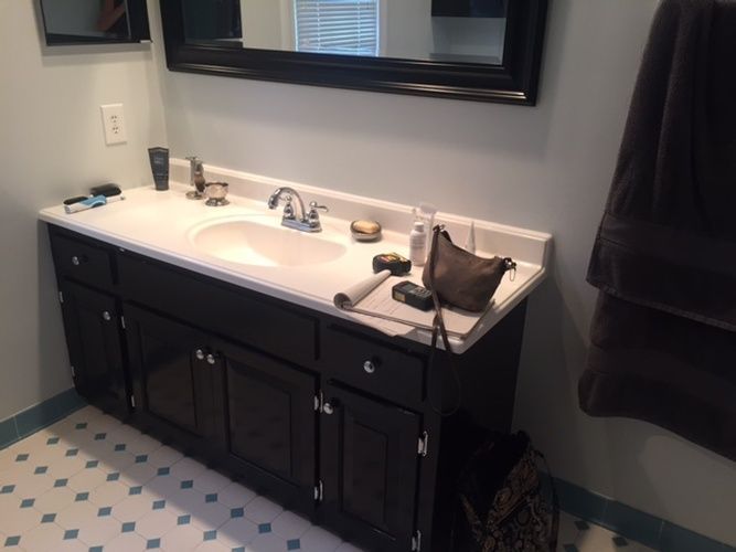 A bathroom with two sinks and a mirror