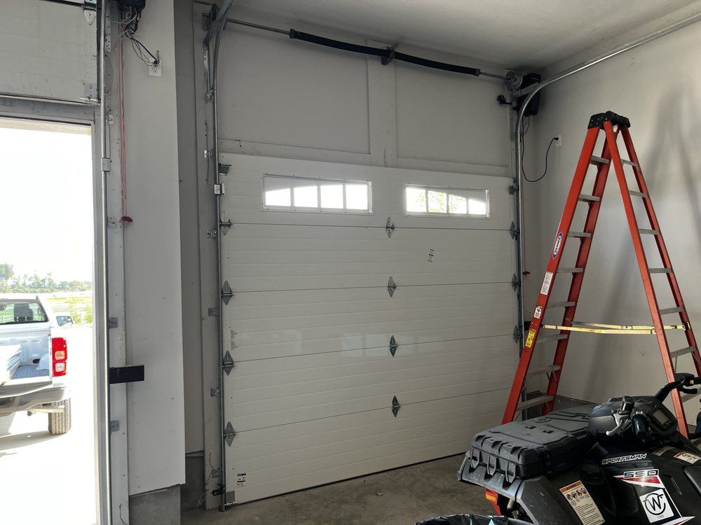 A garage with a garage door and a ladder in it.
