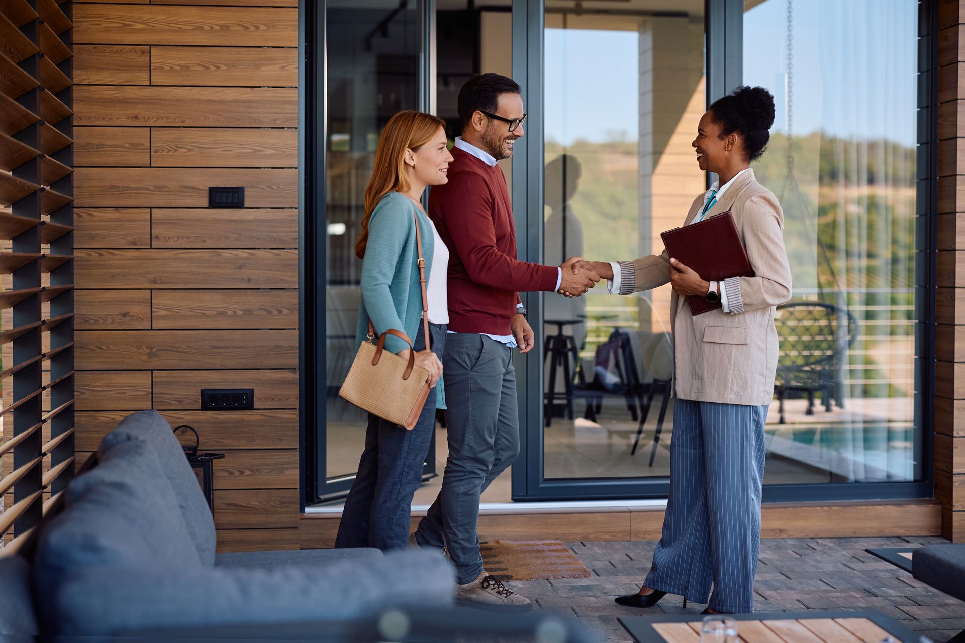 A young couple is meeting with a real estate agent. A young couple is meeting with a real estate agent.