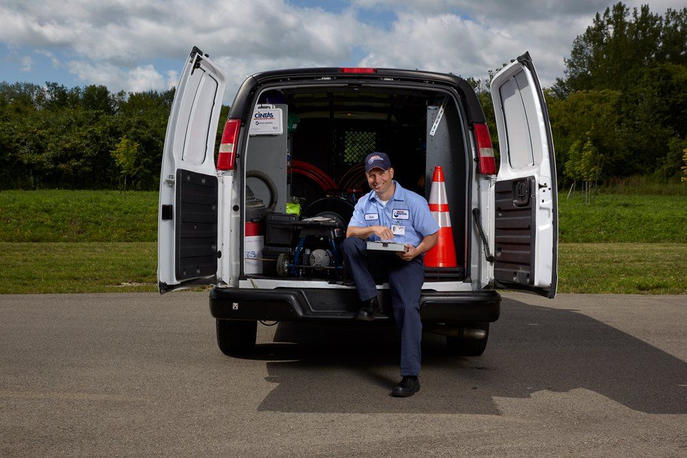 A man is sitting in the back of a van