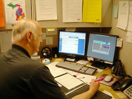 Worker at computer — Kalamazoo, MI — Roto-Rooter of Southwest Michigan