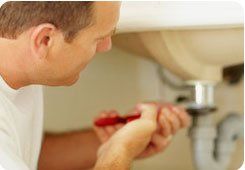 Domestic plumbing - South East London - The Considerate Plumber - plumber repairing sink pipe