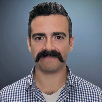 A man with a mustache is wearing a plaid shirt.