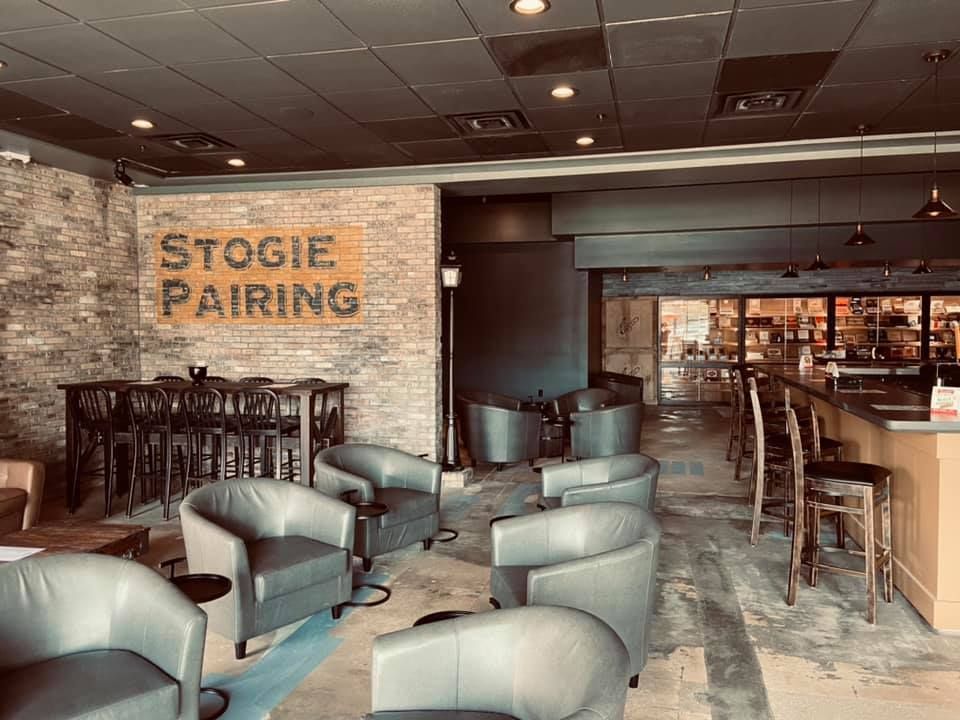 A restaurant with a lot of chairs and tables and a sign that says stogie pairing.