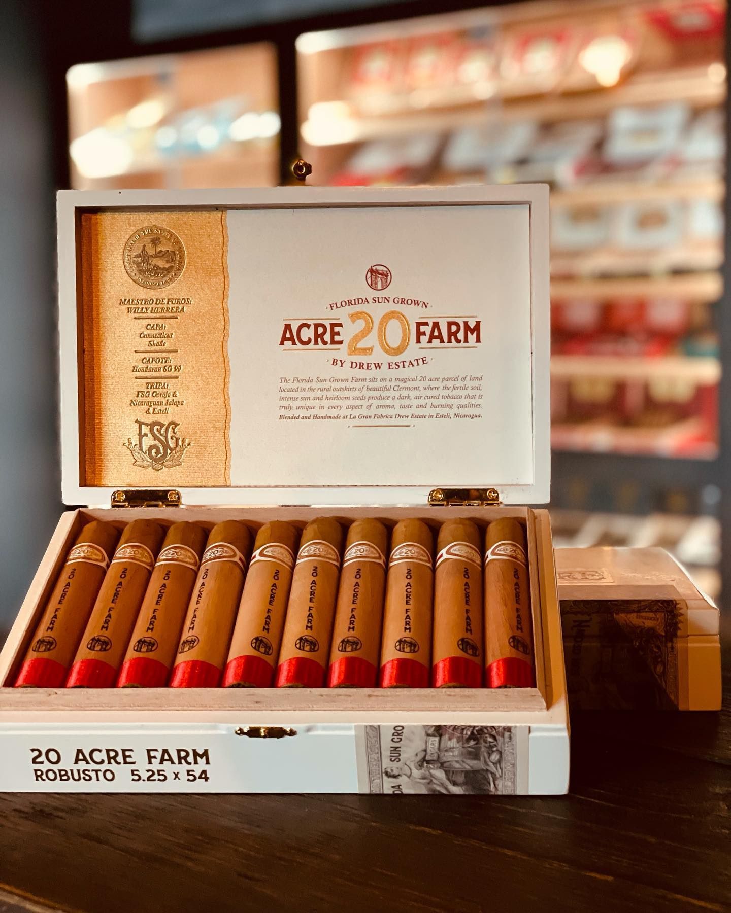A box of 20 acre farm cigars is sitting on a wooden table.