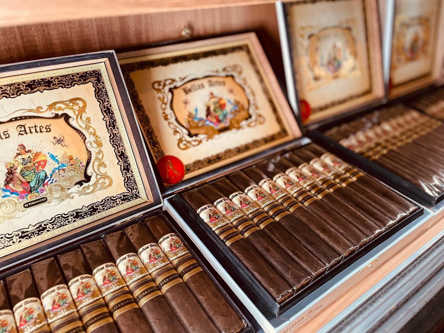 A display of cigars in boxes on a shelf.