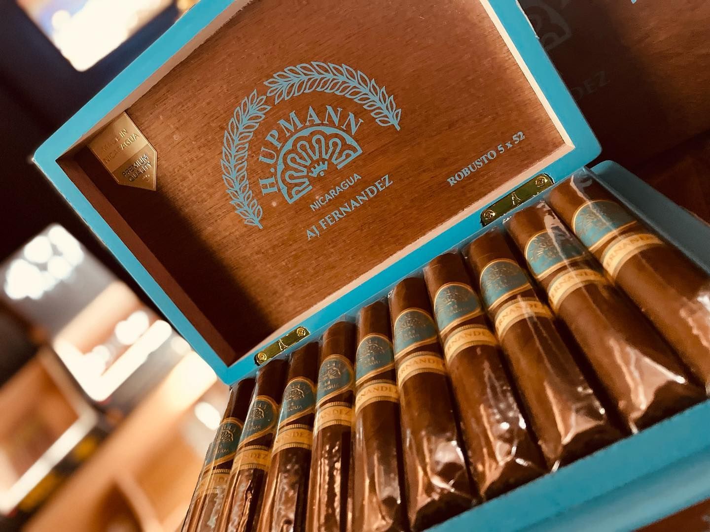 A box of cigars is sitting on a table.