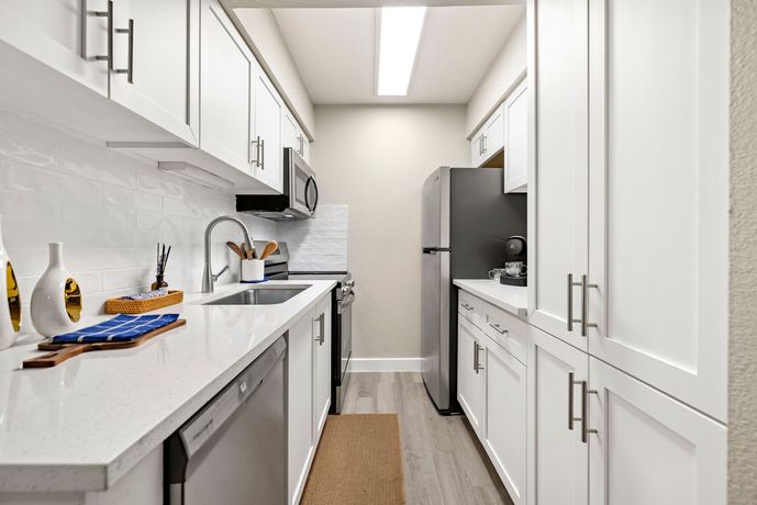 A bathroom with a washer and dryer stacked on top of each other.