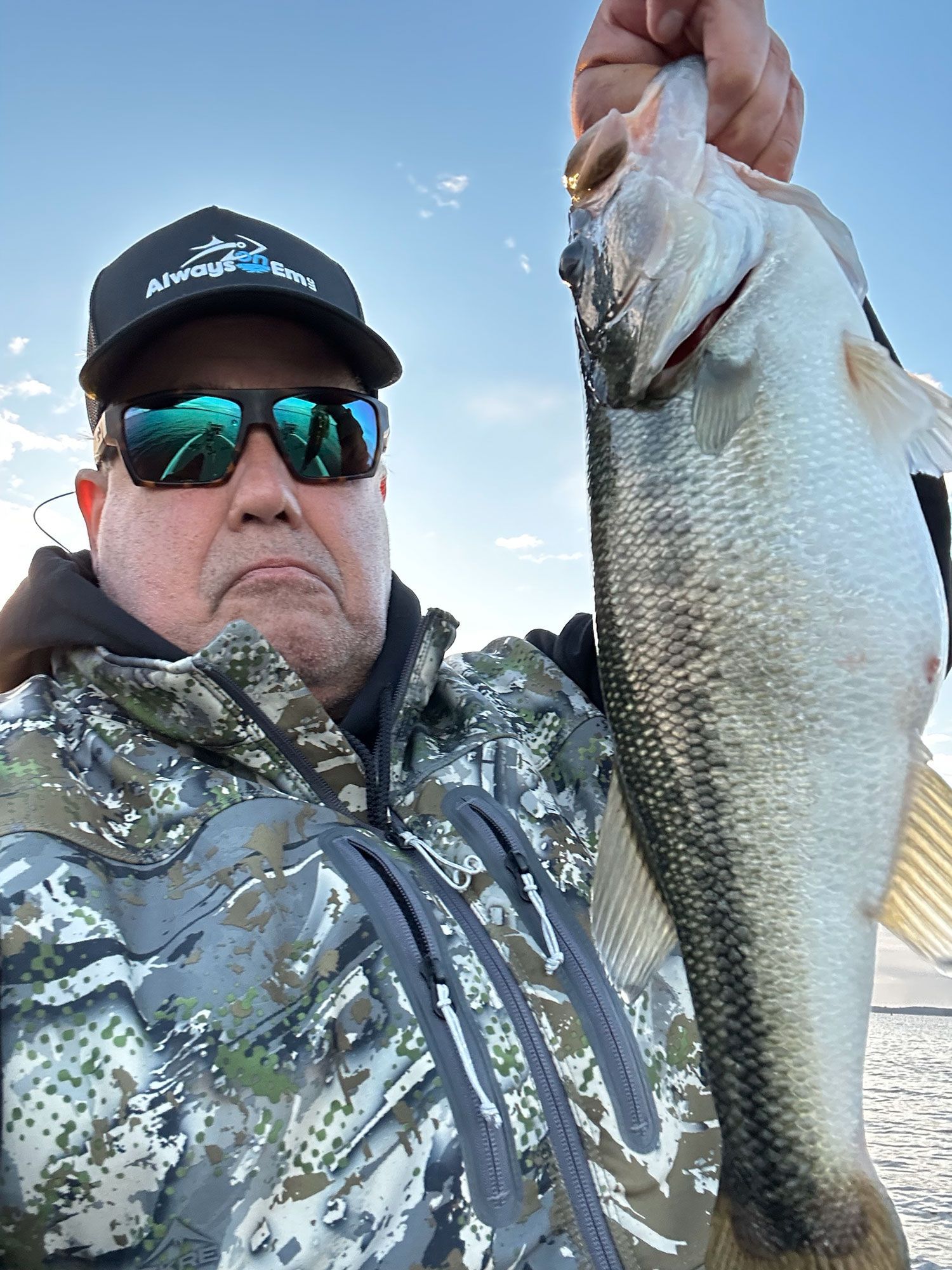 A man is holding a large fish in his hand.