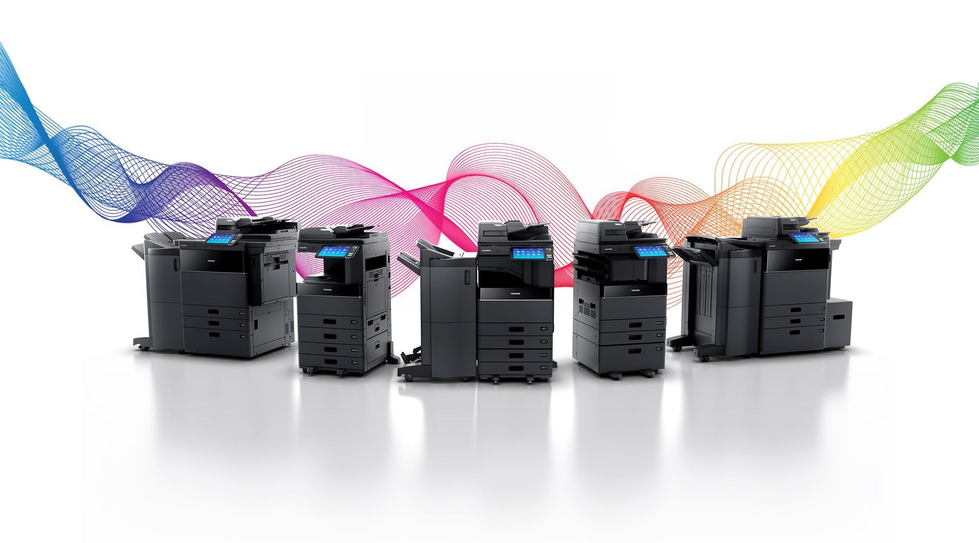 A group of printers sitting next to each other on a white surface.