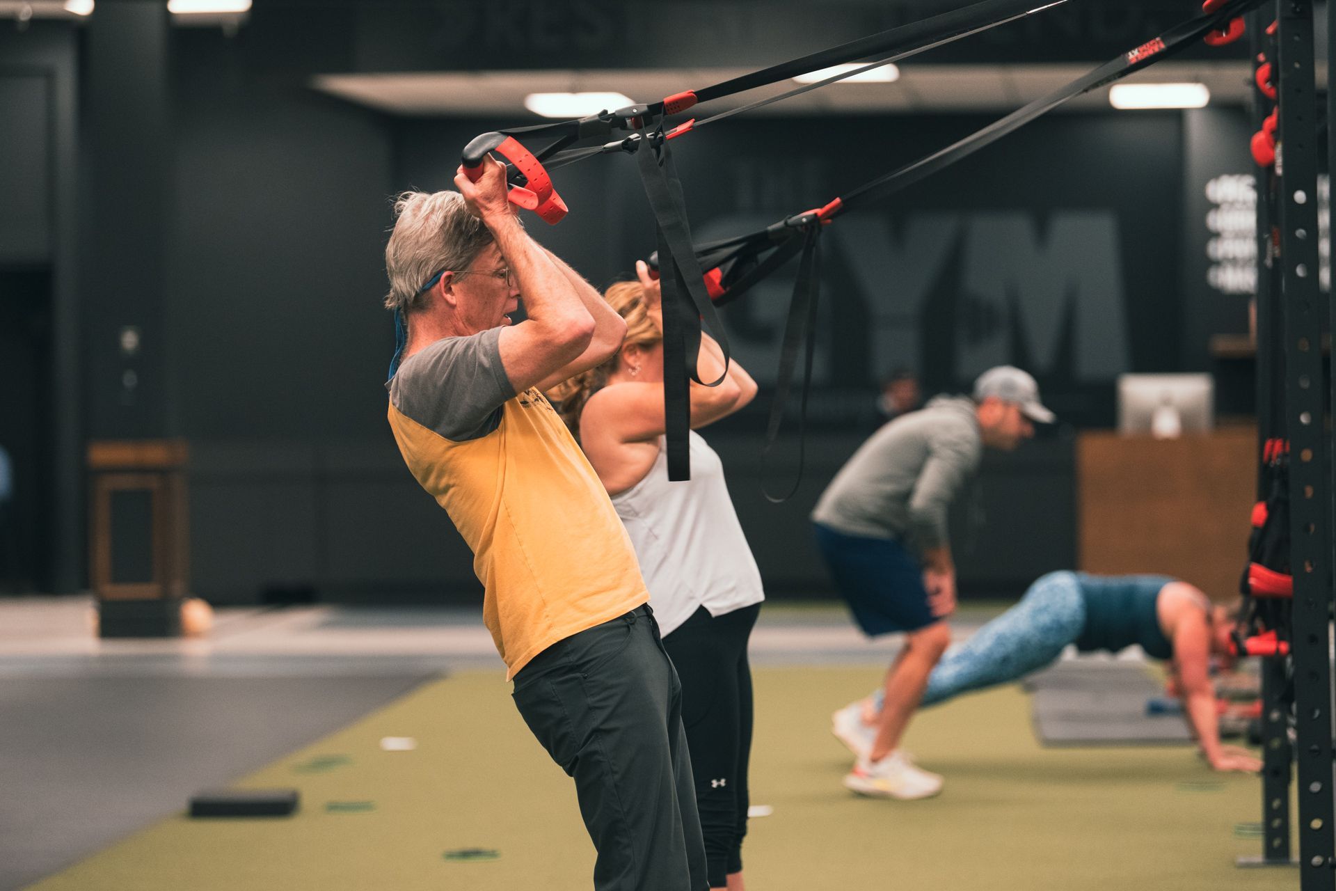 A group of people are doing exercises in a gym.