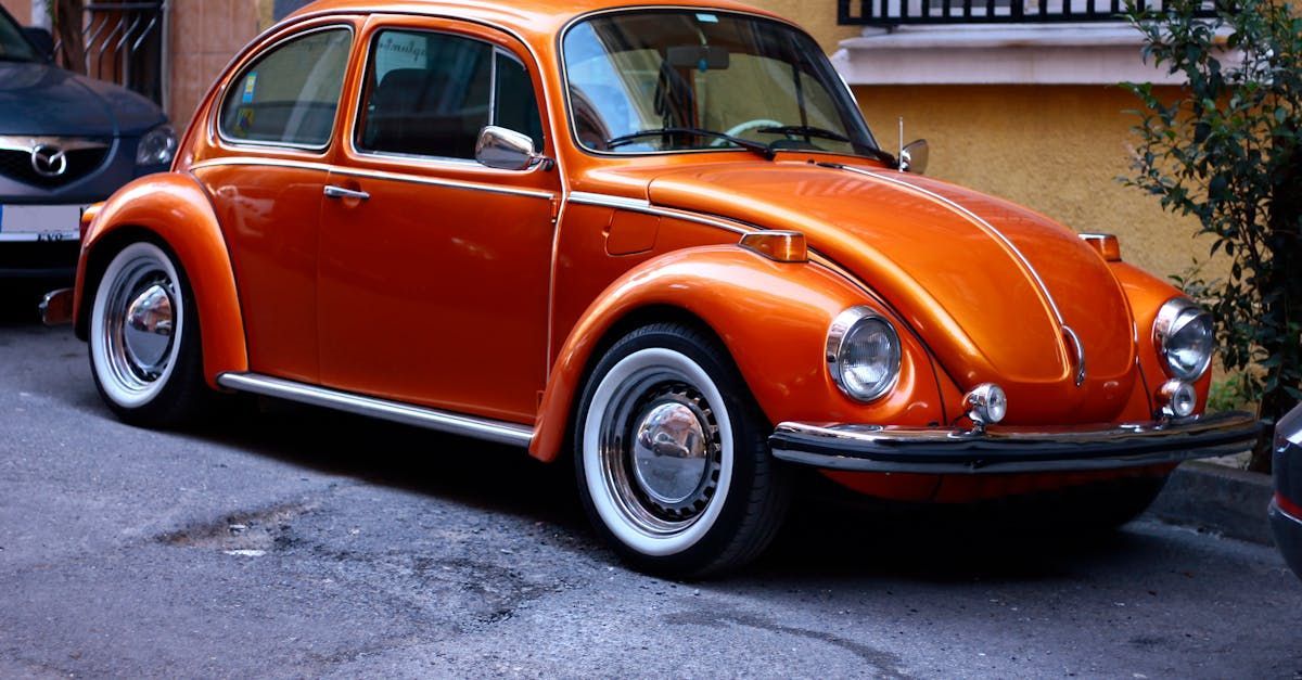 An orange volkswagen beetle is parked on the side of the road  | Houston House of Power