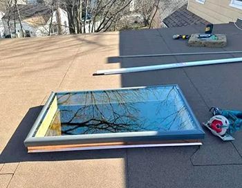 A skylight is being installed on the roof of a house.