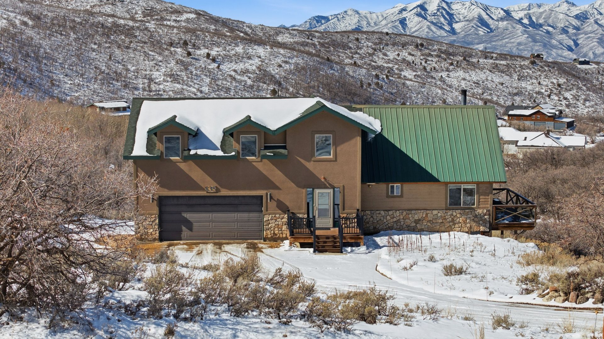 Beautiful exterior view of the mountain cabin at 1880 S Timber Lakes Dr, featuring a durable metal roof and rustic stone accents.