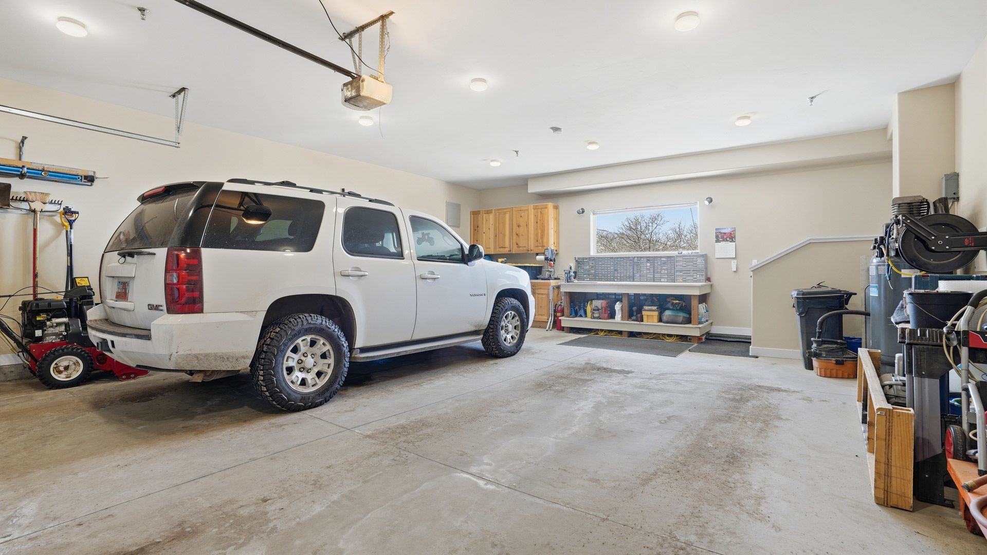 versized, heated two-car garage interior offering ample space for vehicles, snowmobiles, and winter gear at 1880 S Timber Lakes Dr.