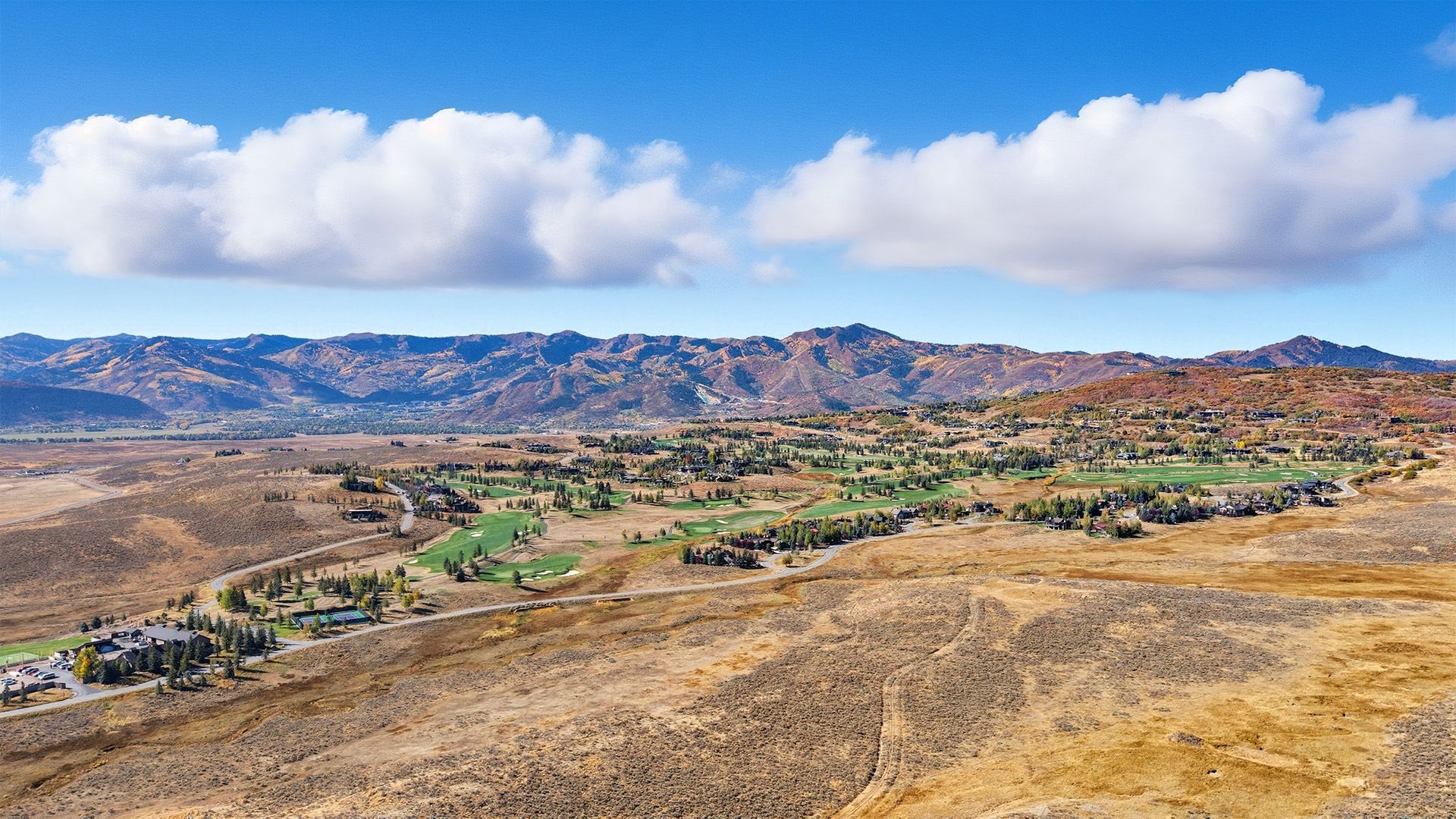 Elevated view from a private 46-acre legacy estate parcel at 8151 Bitner Ranch Rd, overlooking the Glenwild Golf Course and Wasatch Mountains in Park City.