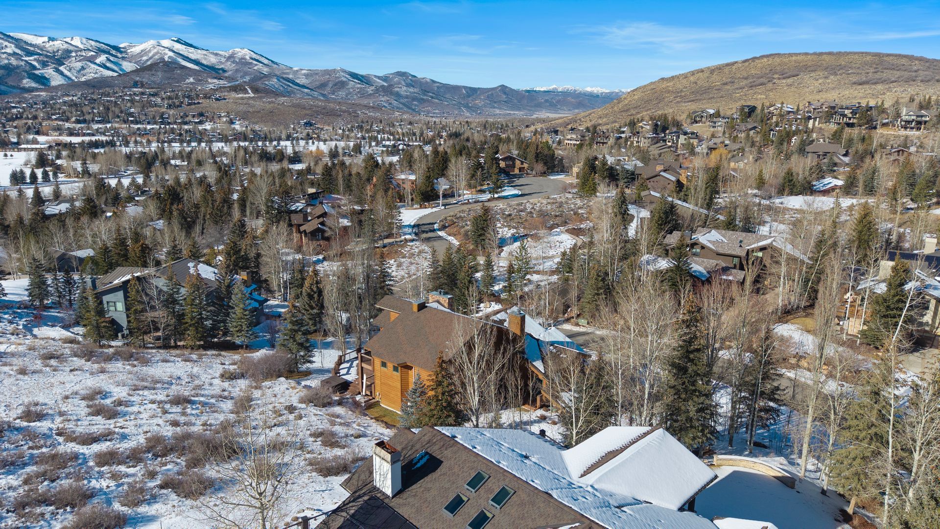 Aerial drone view capturing panoramic ski resort vistas and the Fairway Hills landscape from the property.