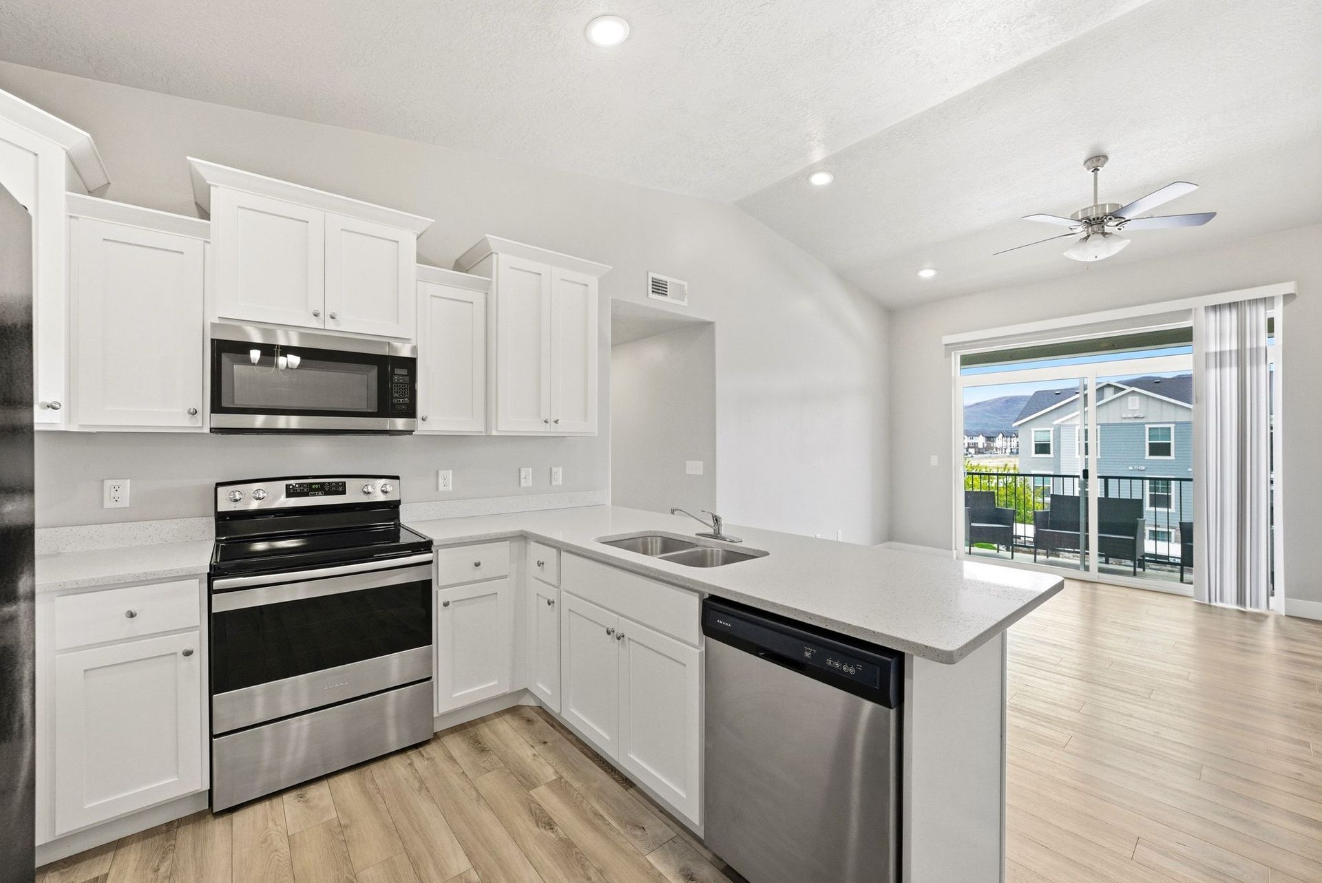 Living area with vaulted ceilings in top-floor Heber City condo for sale.