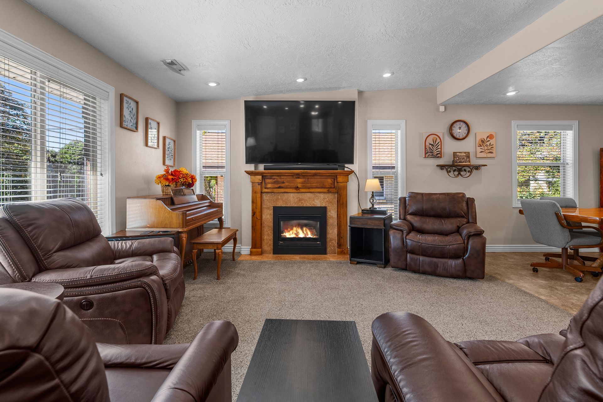 Spacious Living Room featuring Gas Fireplace and Large Windows - Main Level at 2125 E Logan Ave