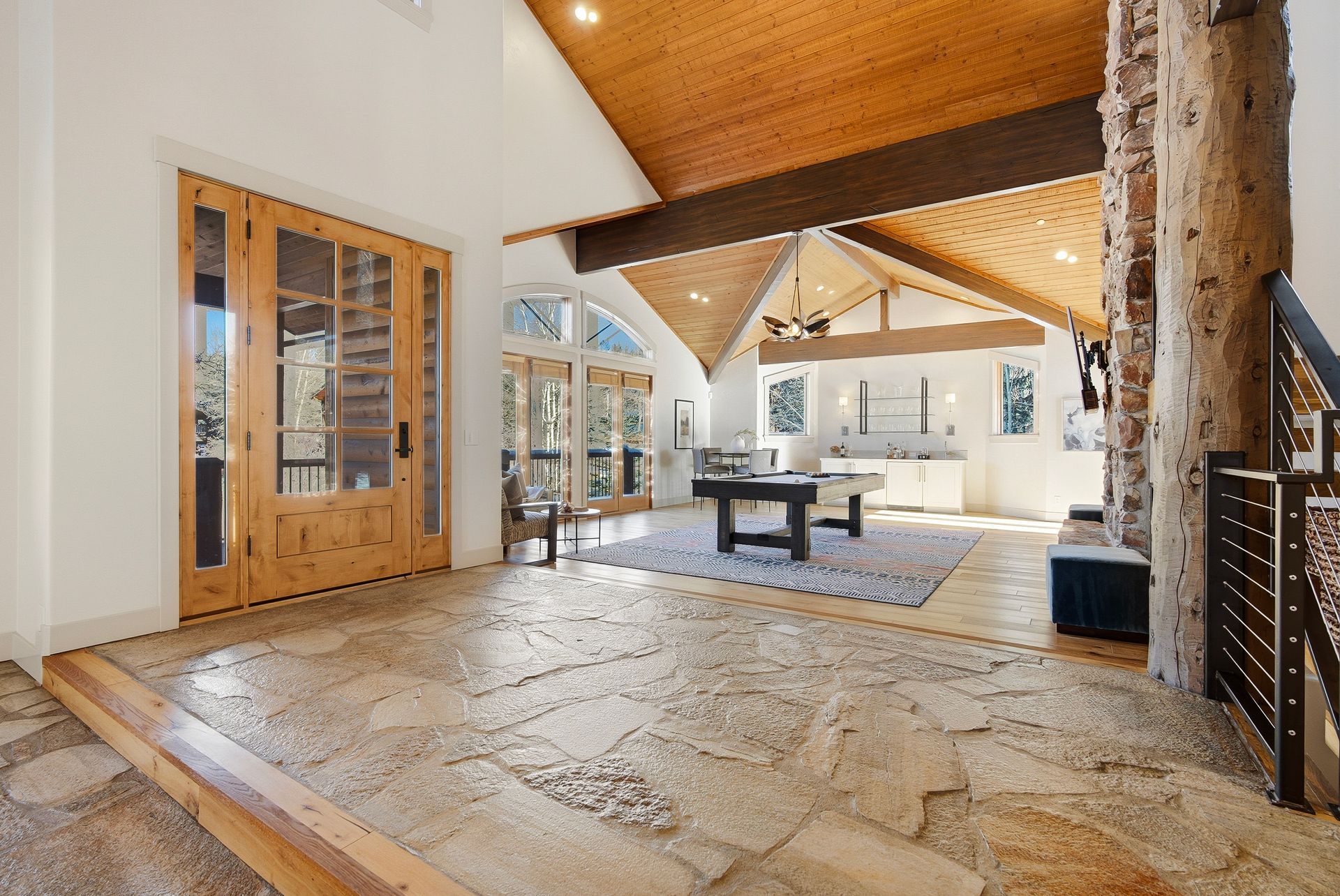 Grand foyer entryway looking into the lower level entertainment lounge and game room.