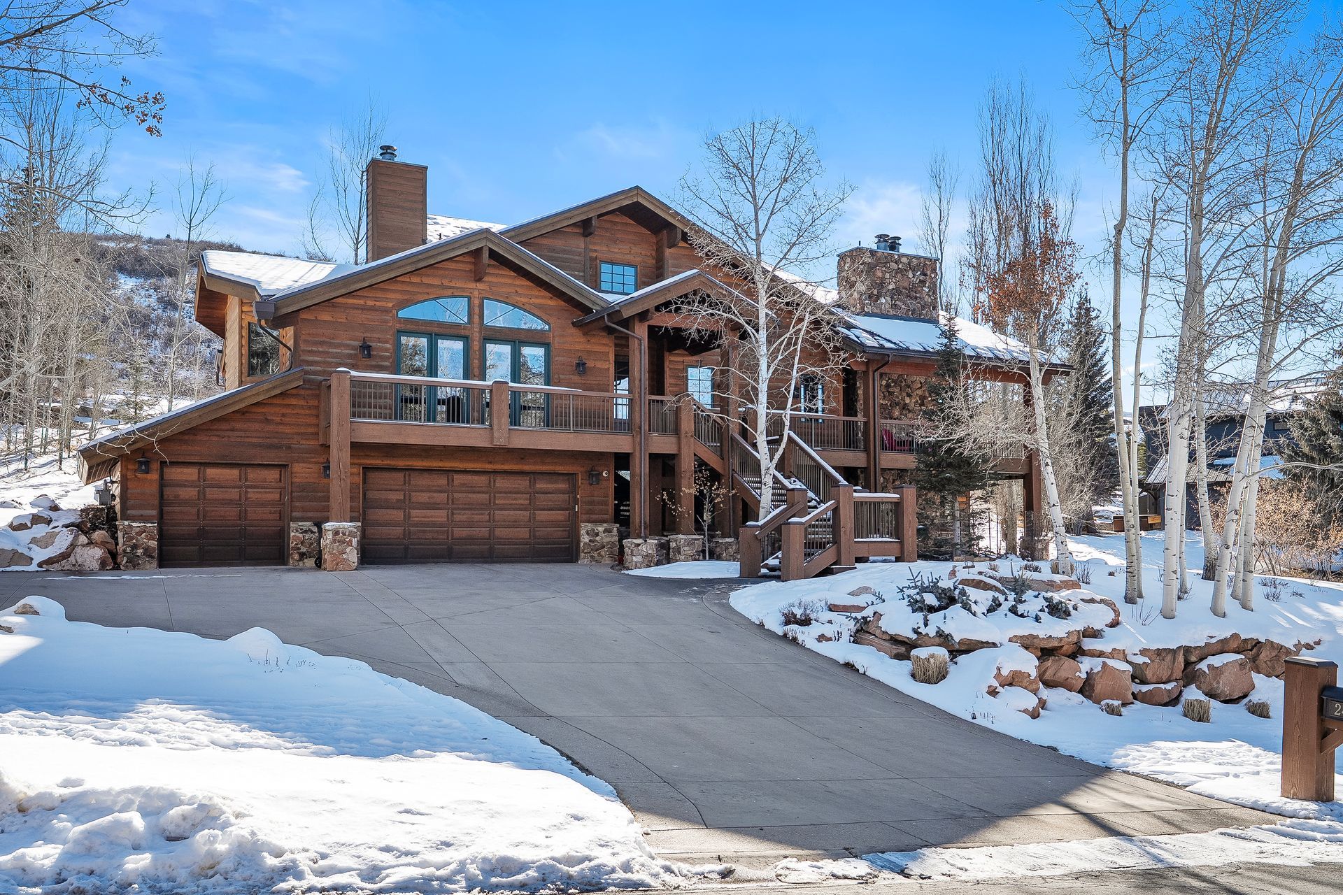 Exterior front view of 2490 Silver Cloud Dr, a luxury Mountain Contemporary estate in Park Meadows, Park City.