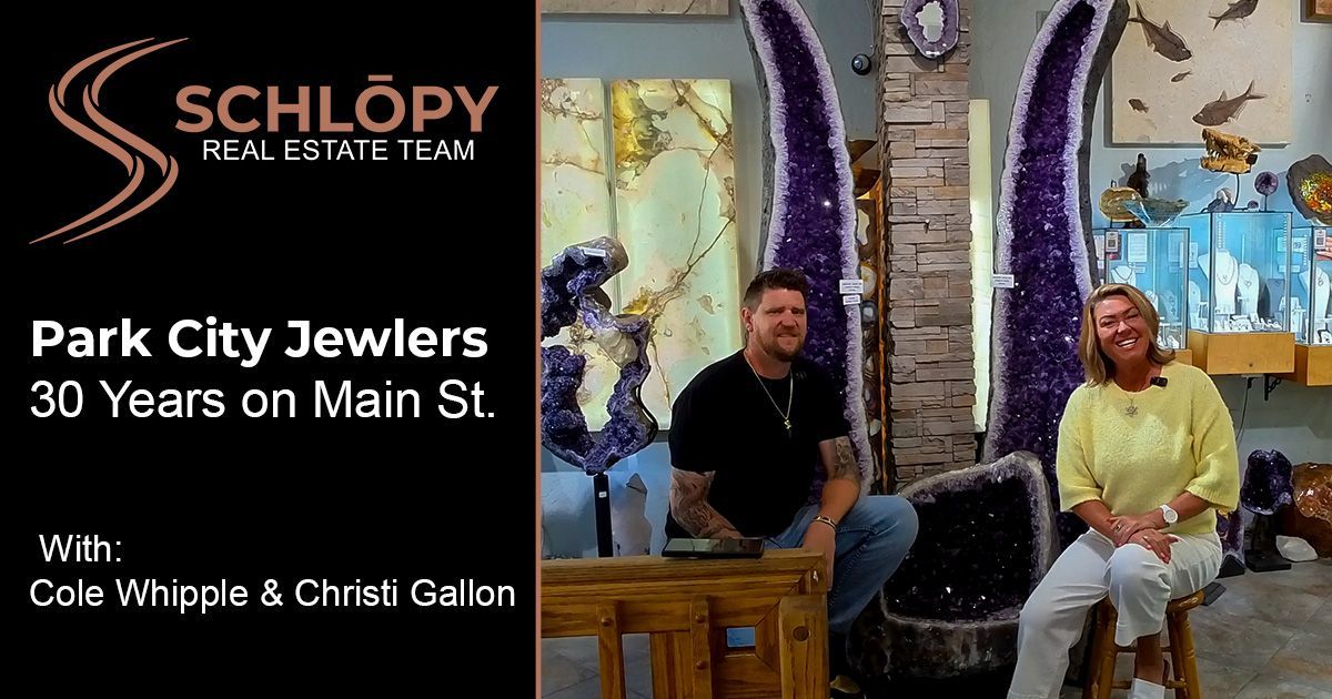 Christi Gallon of Team Schlopy Real Estate and Cole Whipple smiling inside the Park City Jewelers showroom on historic Main Street.