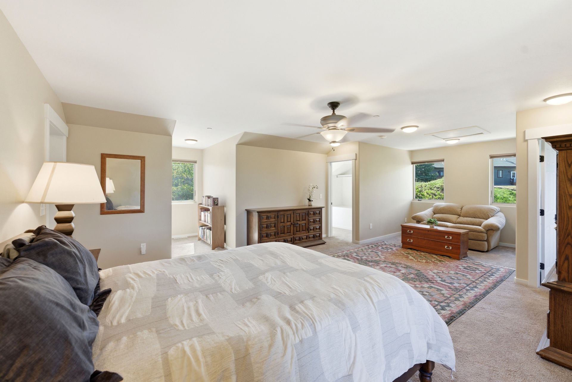 Spacious primary bedroom retreat with vaulted ceilings and dedicated office space in Timber Lakes.