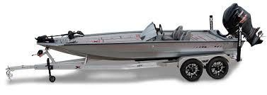 A boat on a trailer, silver in color with a black motor, sits on a white background.