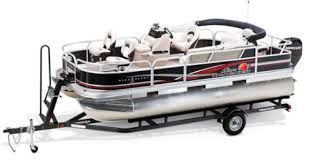 Pontoon boat on trailer, black and red accents, white seating, silver pontoon tubes.