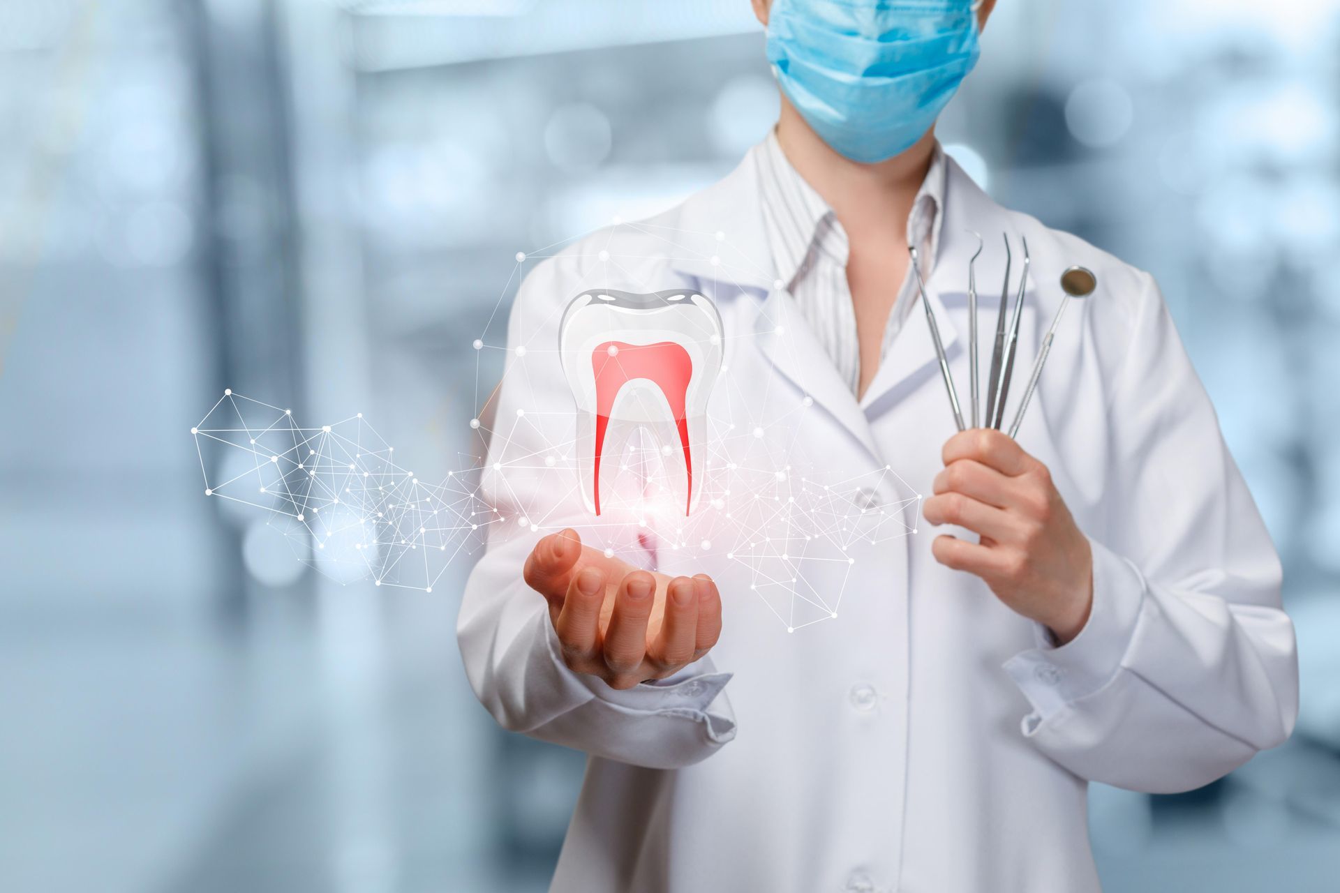 Dentist in lab coat and mask holds dental tools and a glowing tooth illustration.
