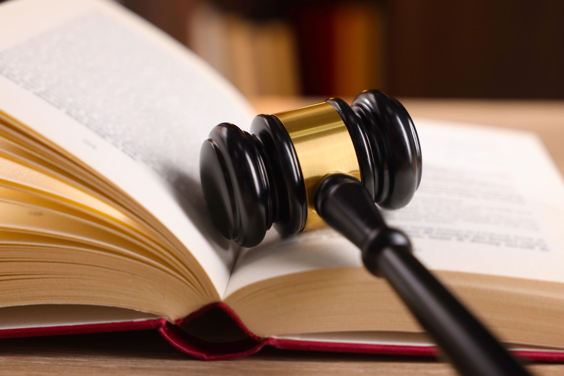 Gavel resting on an open law book, indoors, close-up.