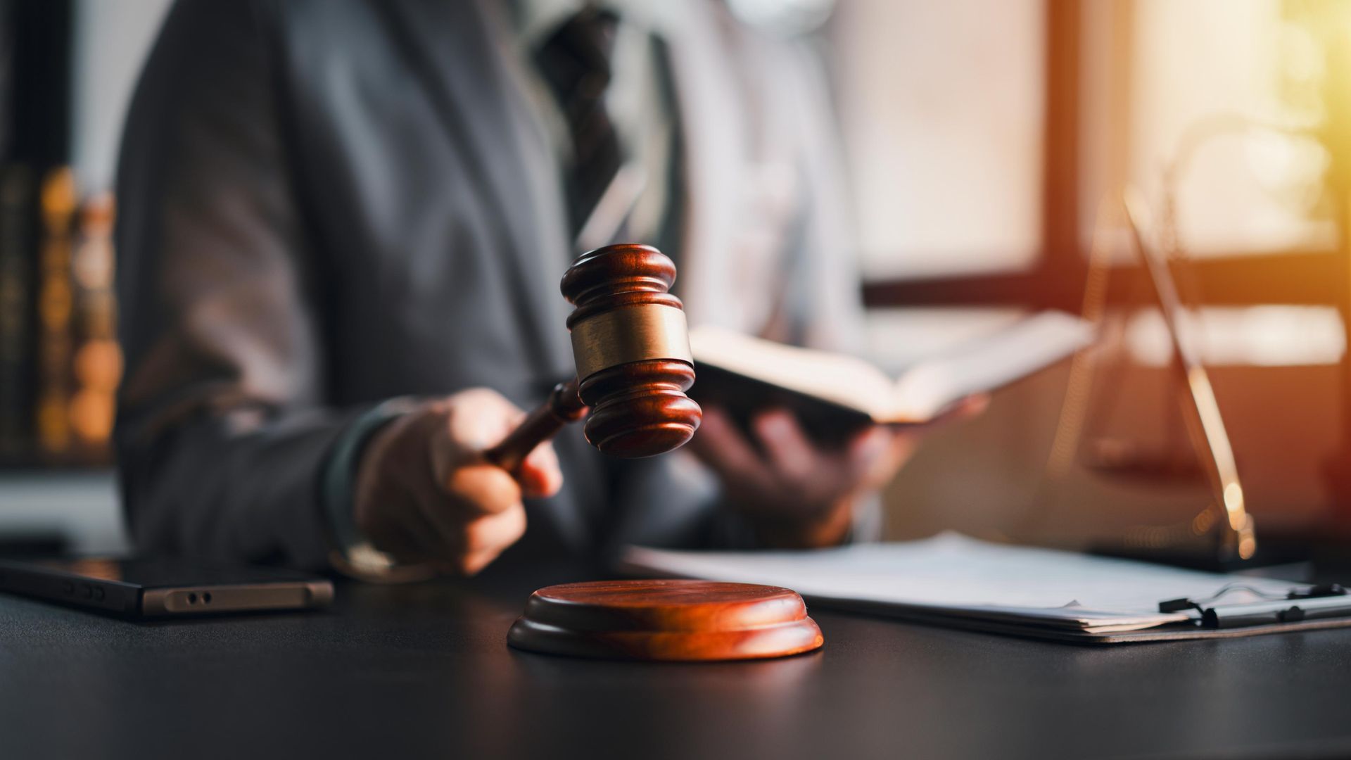 A living room with two couches, a fireplace, and a ceiling fan.