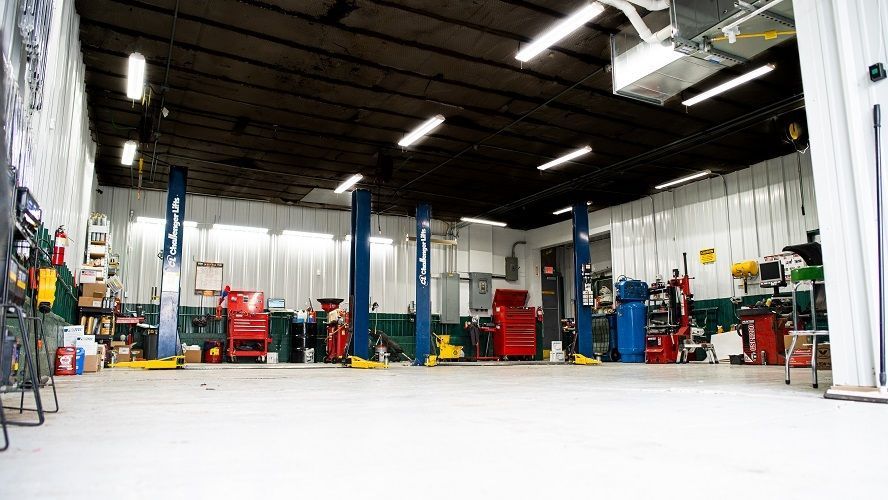 A Mechanic Is Working On A Car Engine | Advanced Car Care Center LLC