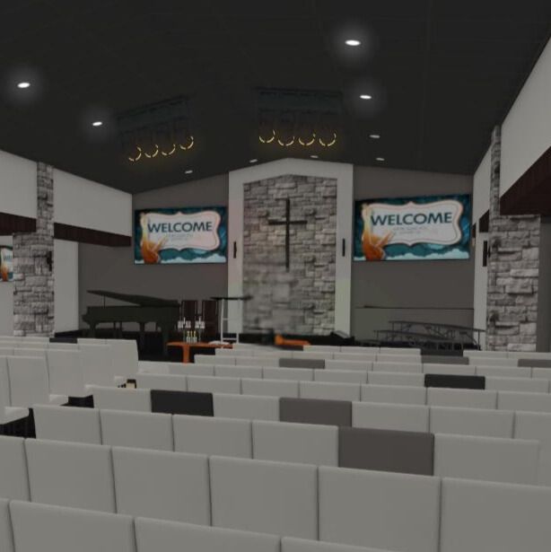 Large group of people standing in a church. A cross hangs on the wall, and colored light shines.