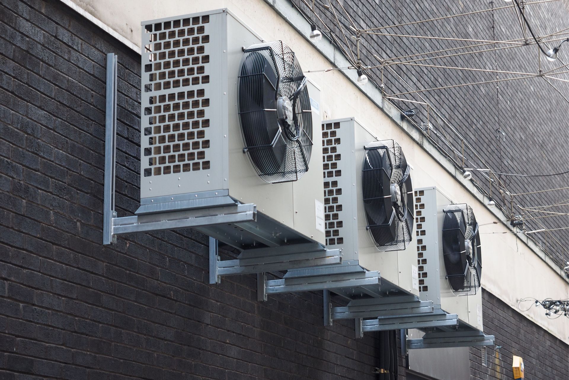 A row of air conditioners mounted on the side of a building