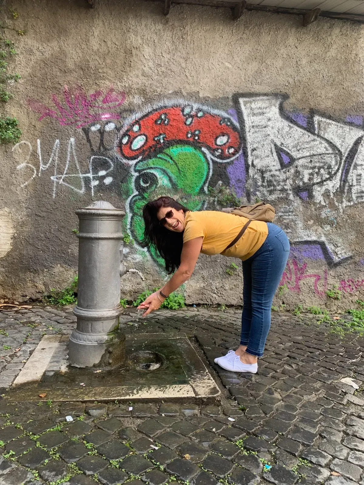 Paula leaning by a fountain in Florence