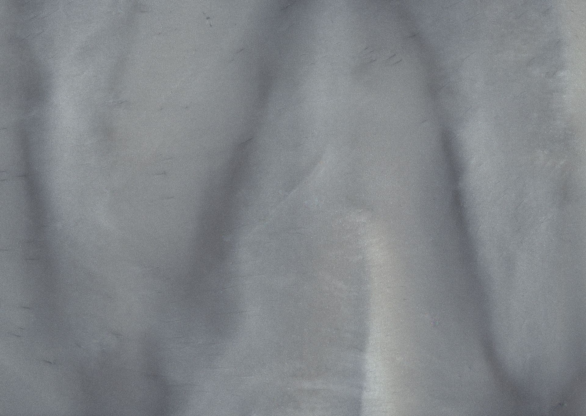 Textured, pale blue surface with subtle folds and shadows.