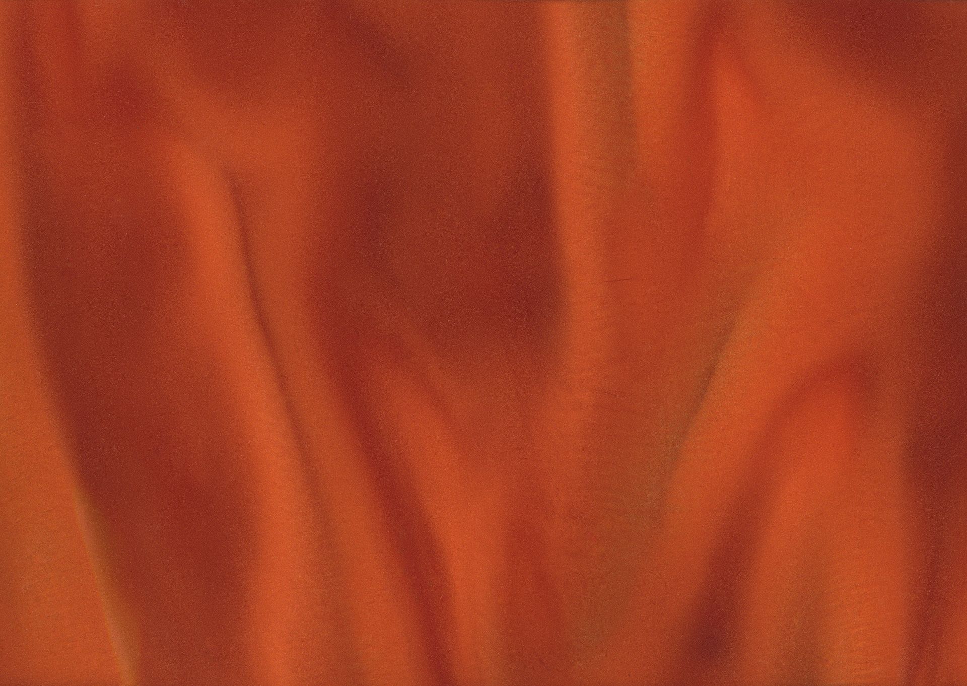 Close-up of vibrant orange fabric with soft folds and textured appearance.