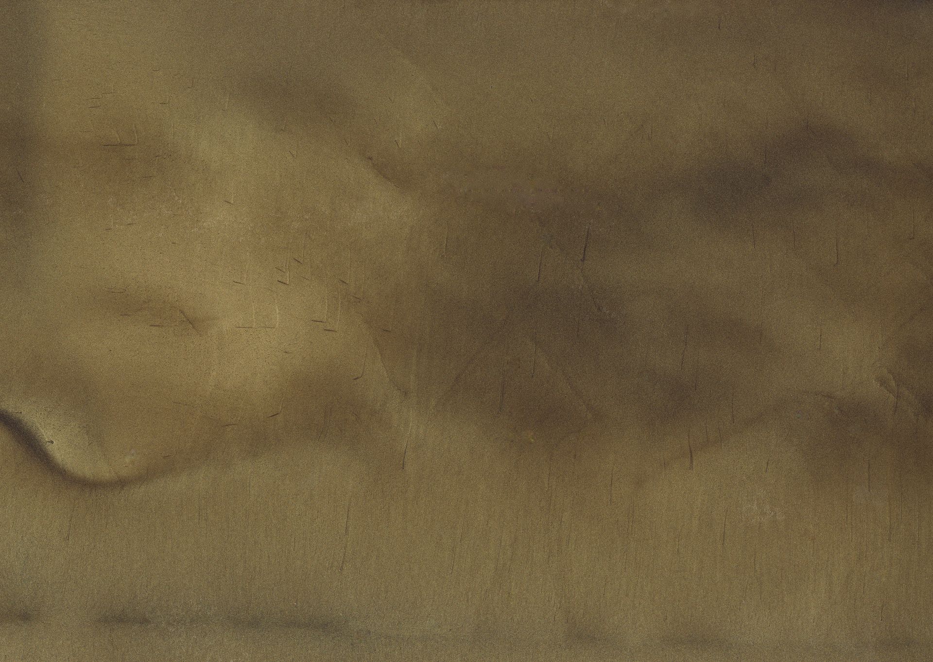 A close-up view of sand, with shades of green and brown swirling together, creating an abstract textured pattern.