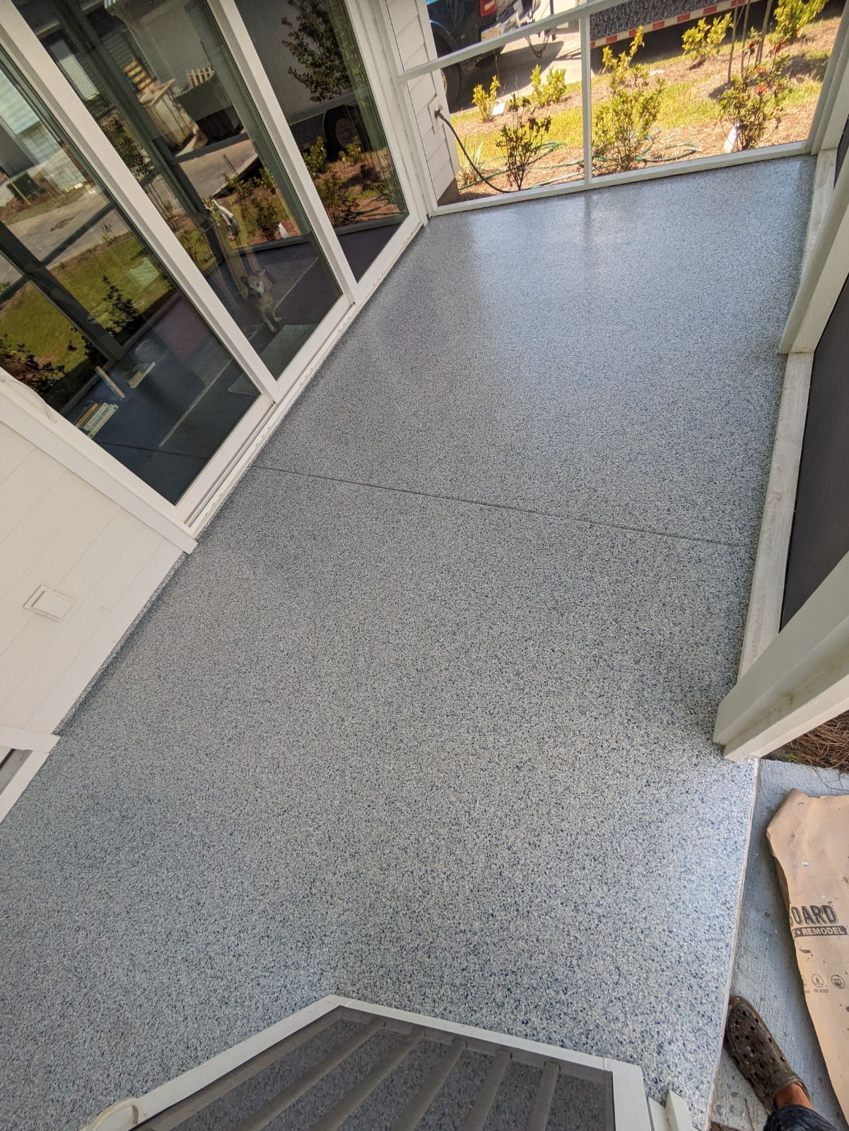 A balcony with a concrete floor and sliding glass doors — Charleston, SC — Lowcountry Surface Coatings