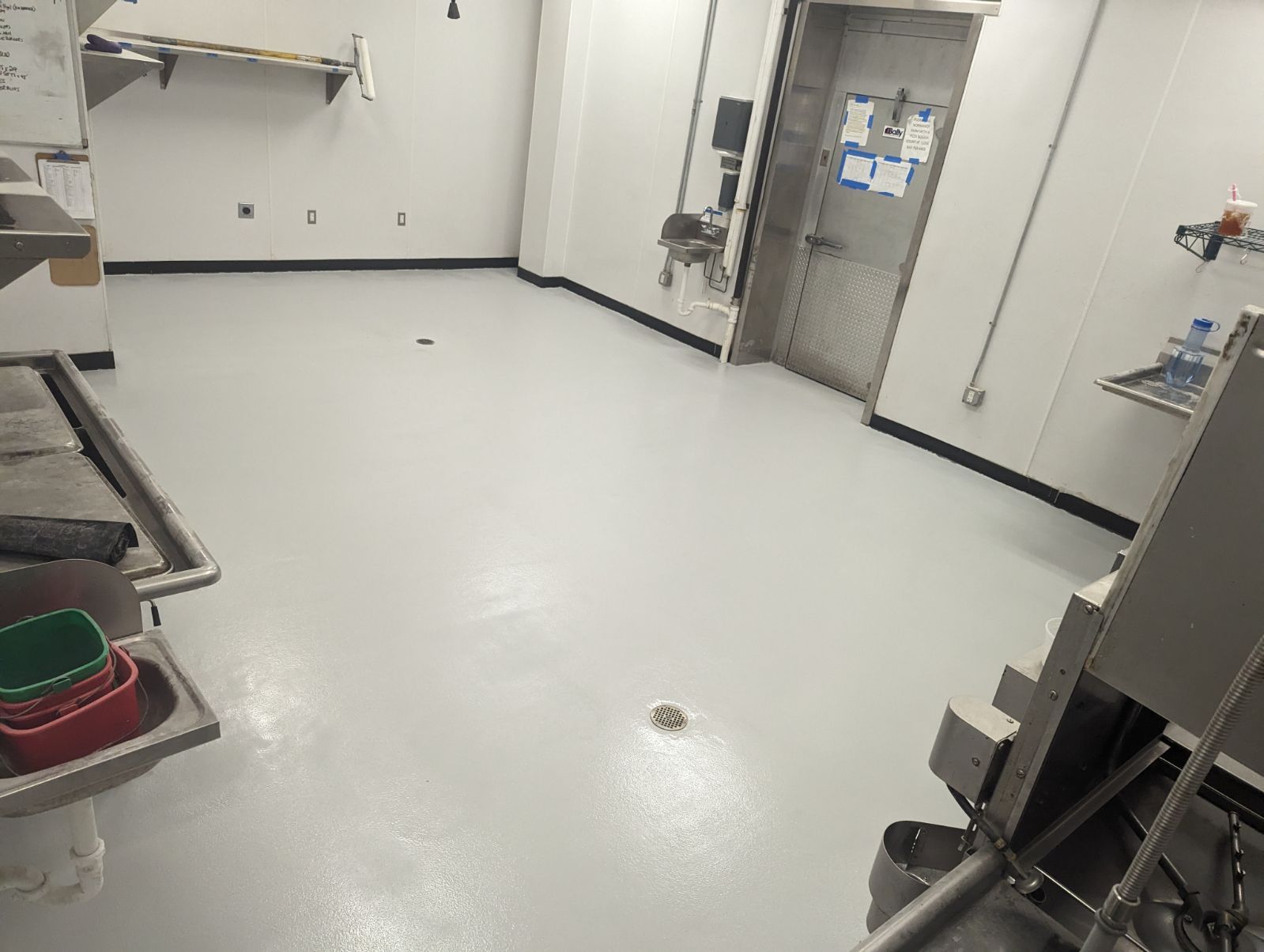 A kitchen with a white floor and a sink.
