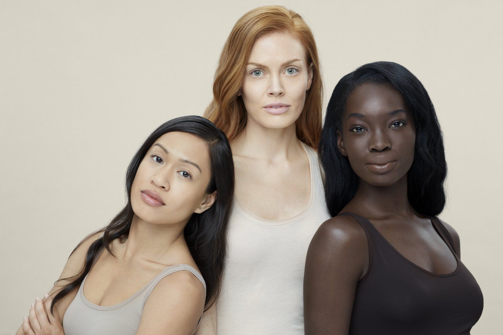 3 women of different backgrounds with beautiful skin