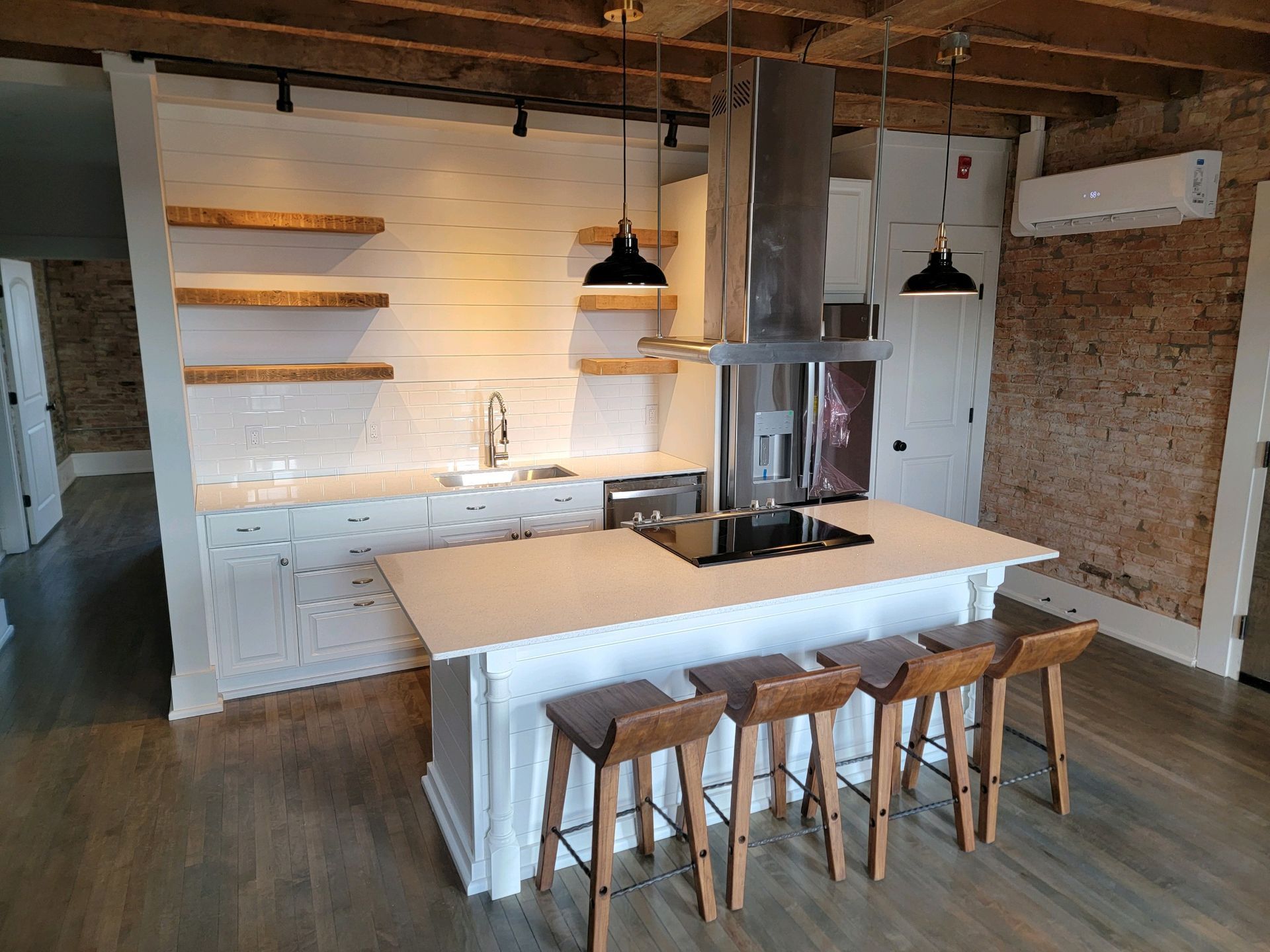 A living room with a couch , table , chair and french doors.