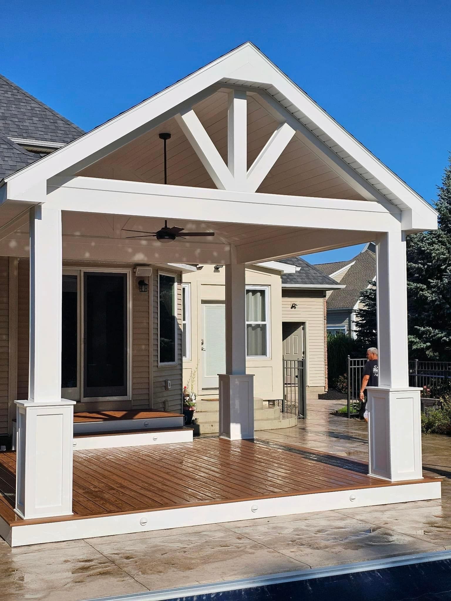 A house with a white porch and a ceiling fan