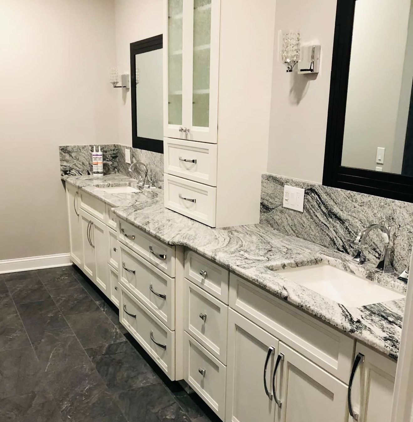 A living room with a dining table and chairs and a kitchen.