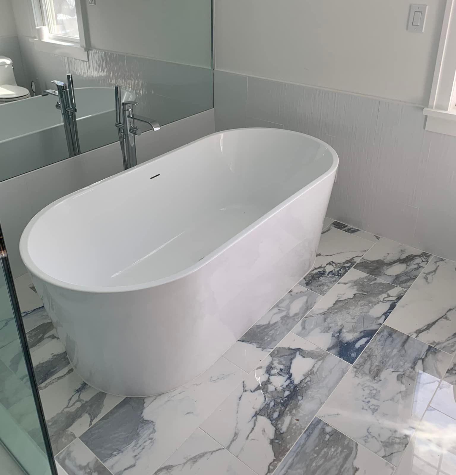 A living room with a couch , table , chair and french doors.