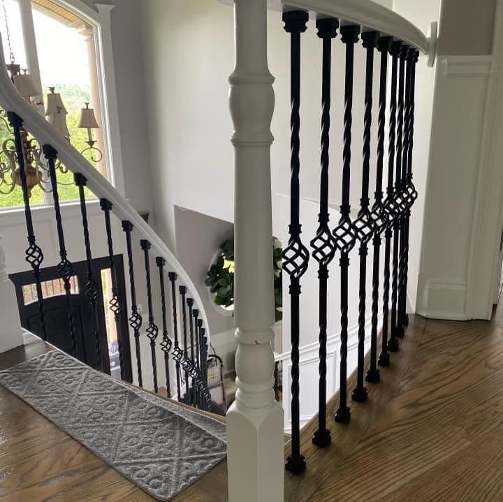 A white staircase with black railings in a house
